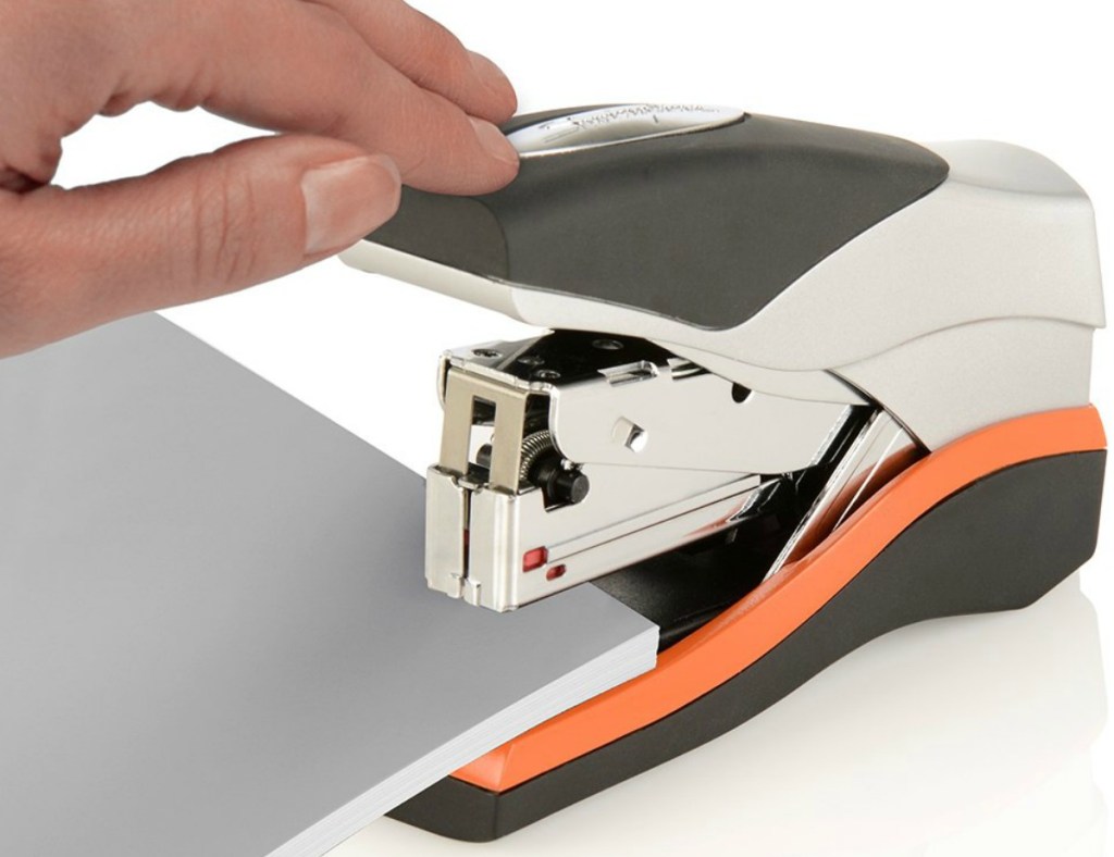 Silver and Orange compact stapler in use