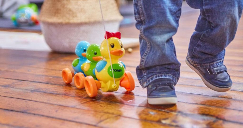 Tomy Toomies Quack Along ducks on hardwood floor