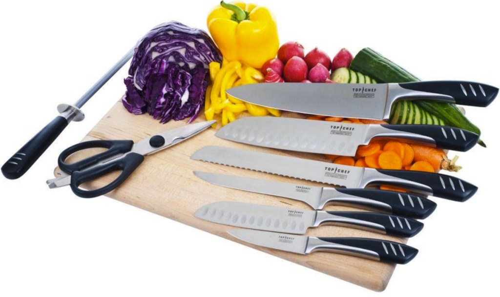 Top Chef-brand knife set on cutting board with peppers and other vegetables