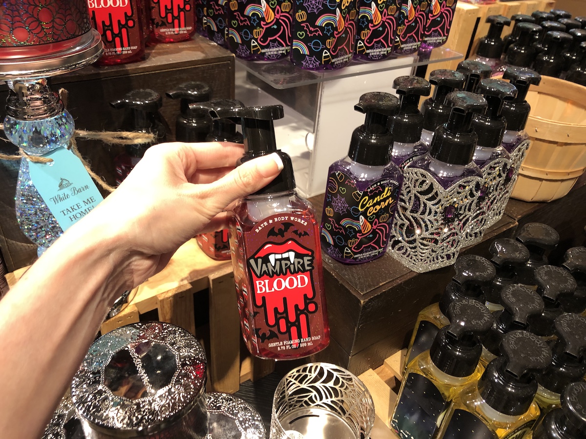 Woman holding bottle of Bath & Body Works Vampire Blood Hand Soap