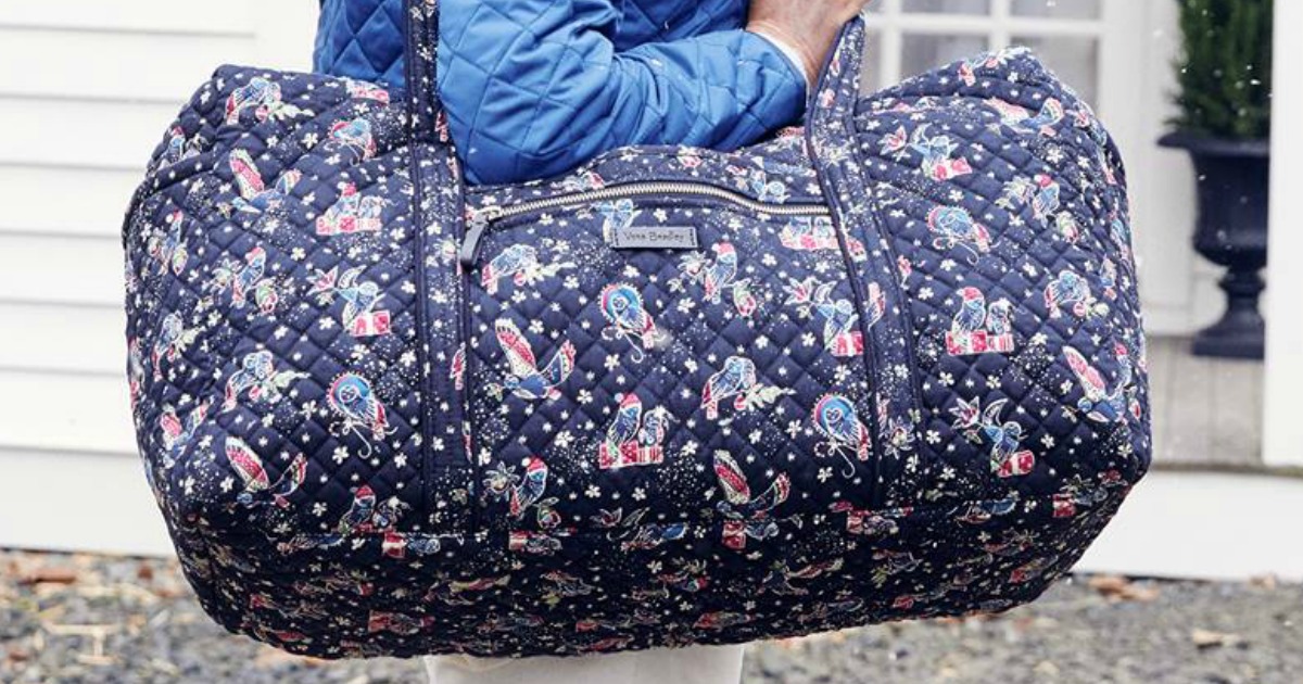 woman carrying travel duffel