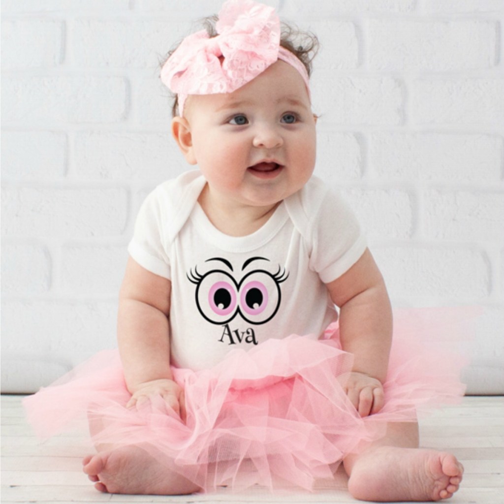 Baby in white personalized onesie and pink tulle tutu with matching headband