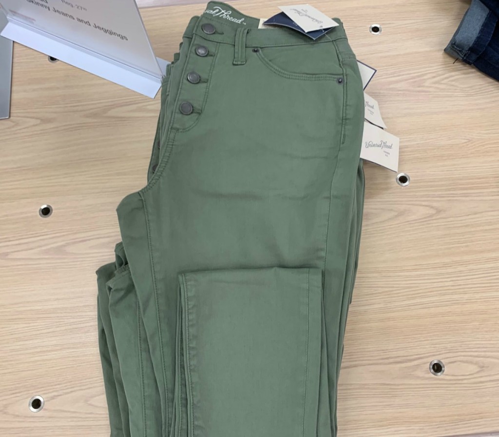 Olive colored women's skinny jeans on shelf at Target