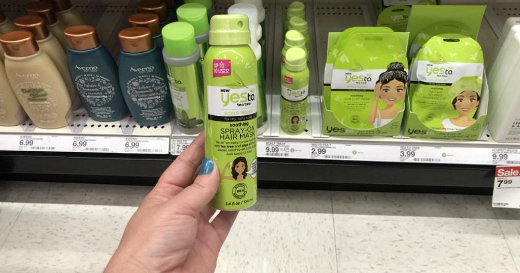 woman holding yes to tea tree hair spray mask