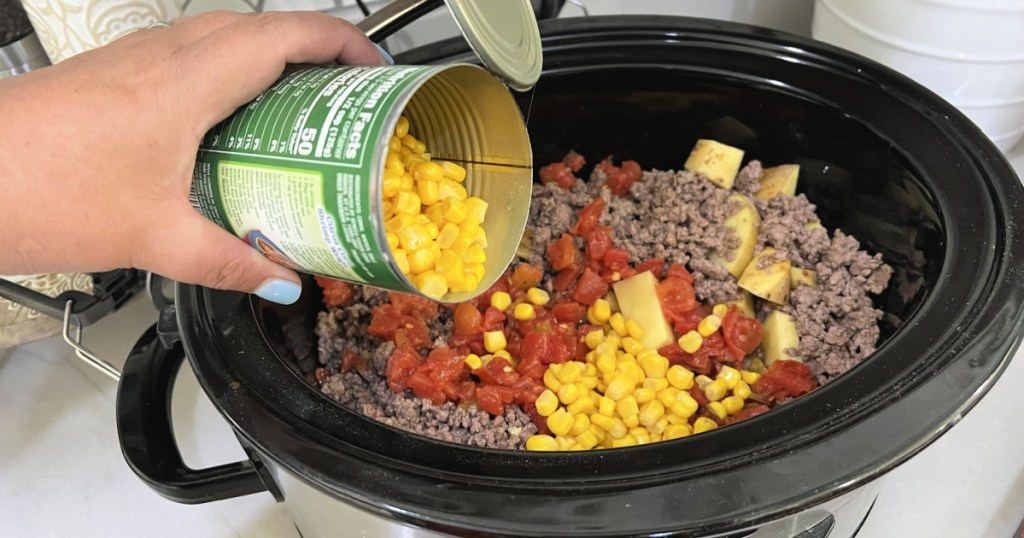 adding corn to slow cooker meal