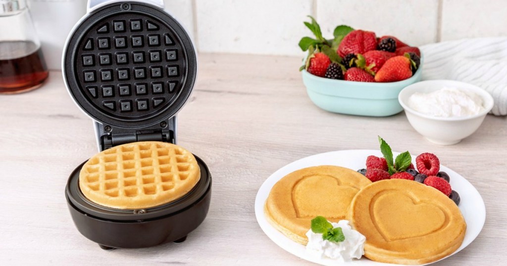 waffle maker with heart shaped waffles on plate
