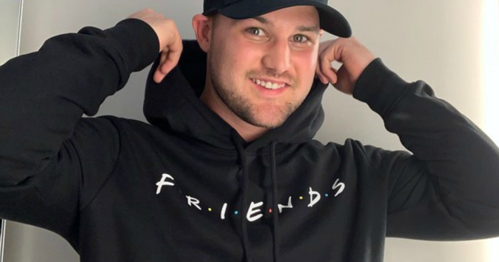 stetson wearing a black friends logo hoodie