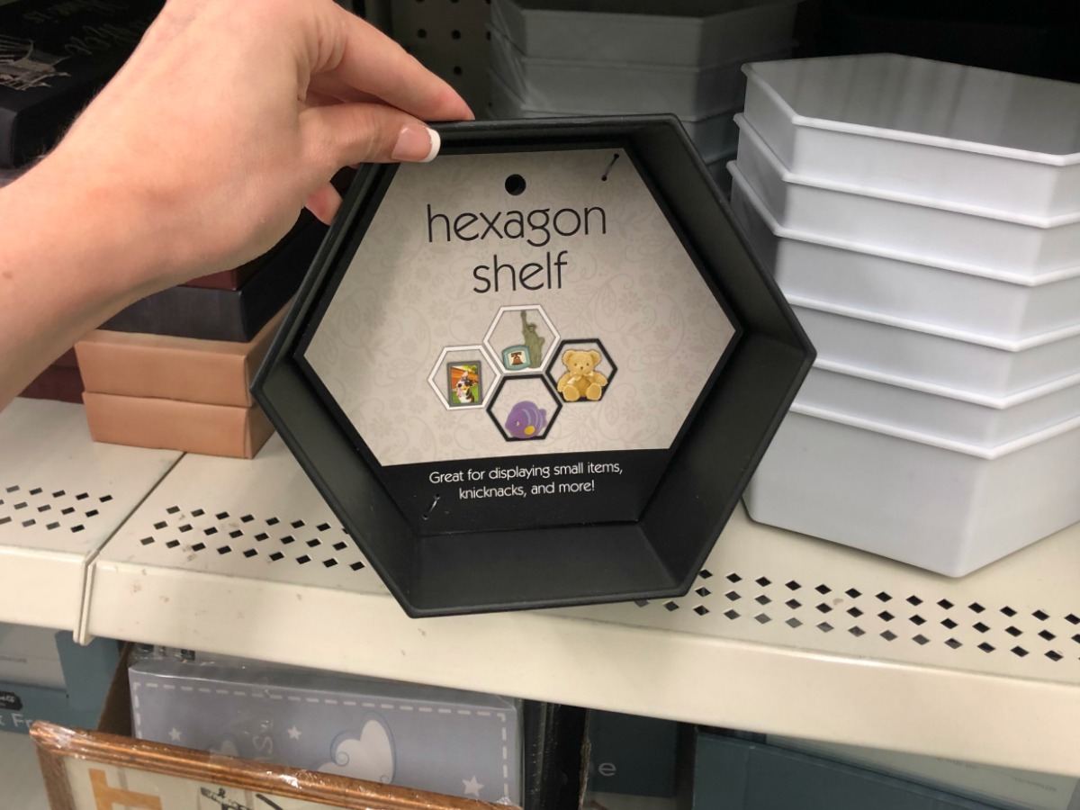 woma holding hexagon shelf at the dollar tree