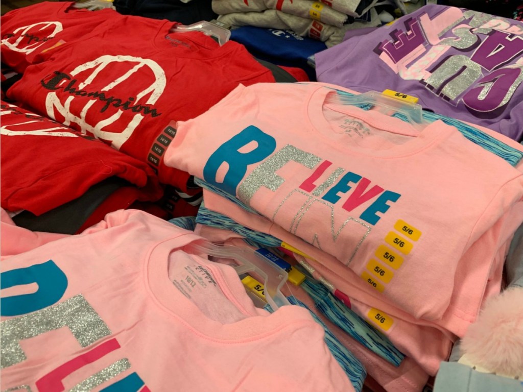 children's clothes folded on table in store