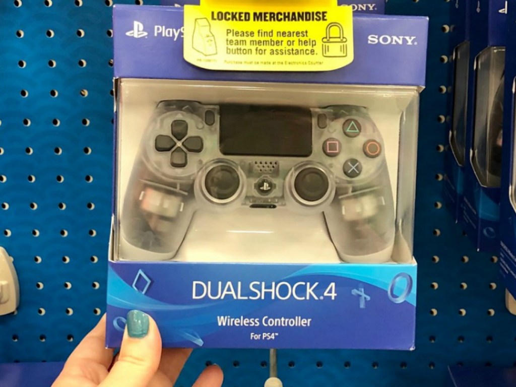 hand holding playstation controller in box inside store