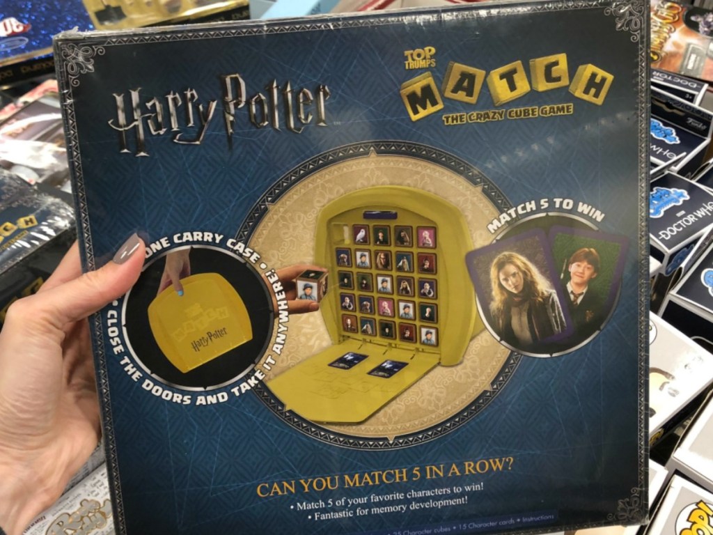 hand holding game with Harry Potter phrases on it