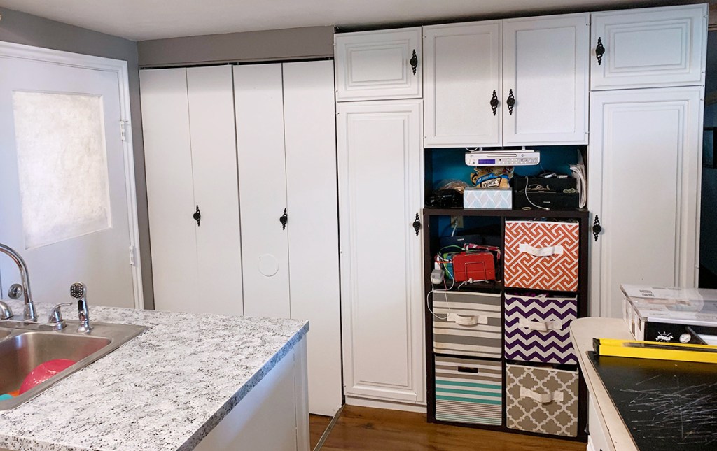 ktichen transformation after with white cabinets, pantry, and refinished countertop