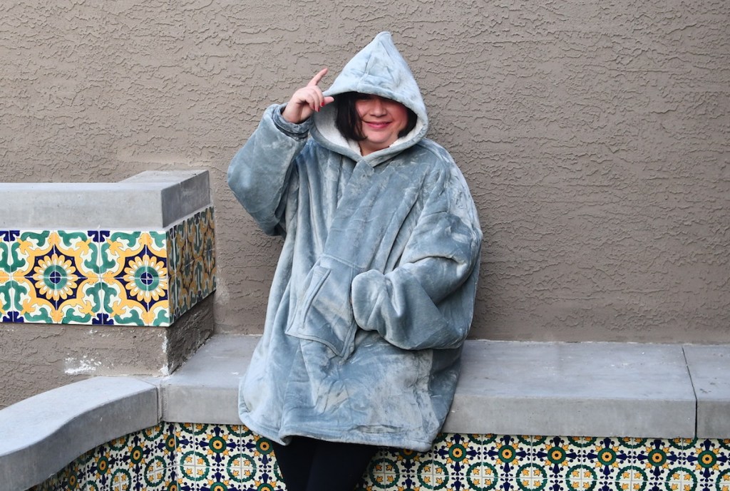 woman wearing an oversized gray blanket hoodie