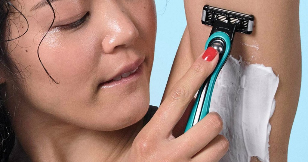 woman shaving arm pits