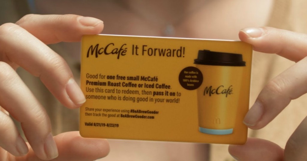 hand holding up maccafe it forward card