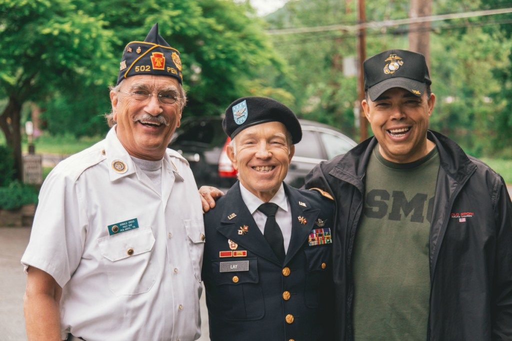 three military men standing side by side in uniform