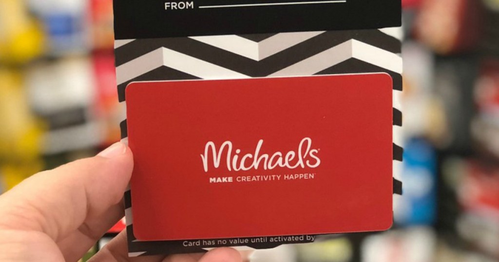 hand holding up michaels gift card