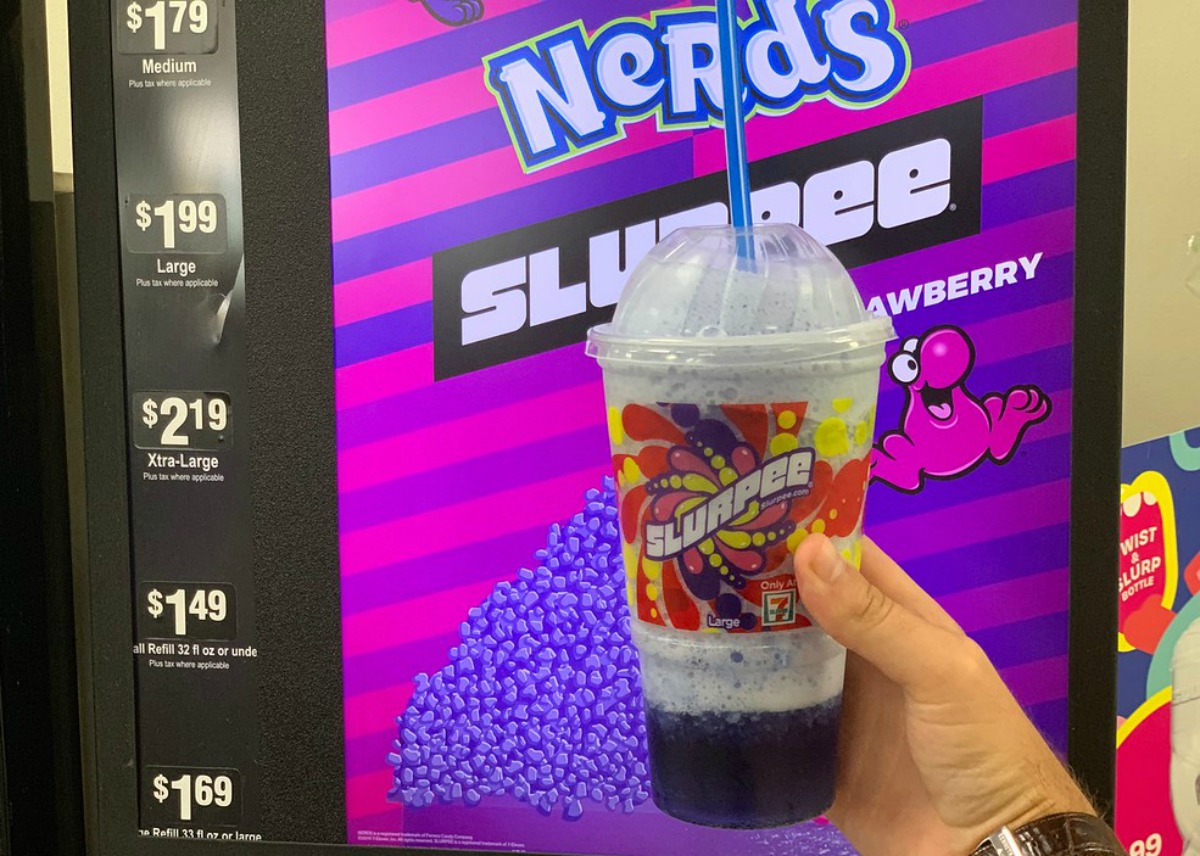 a Nerds slurpee held in front of the machine at 7-Eleven