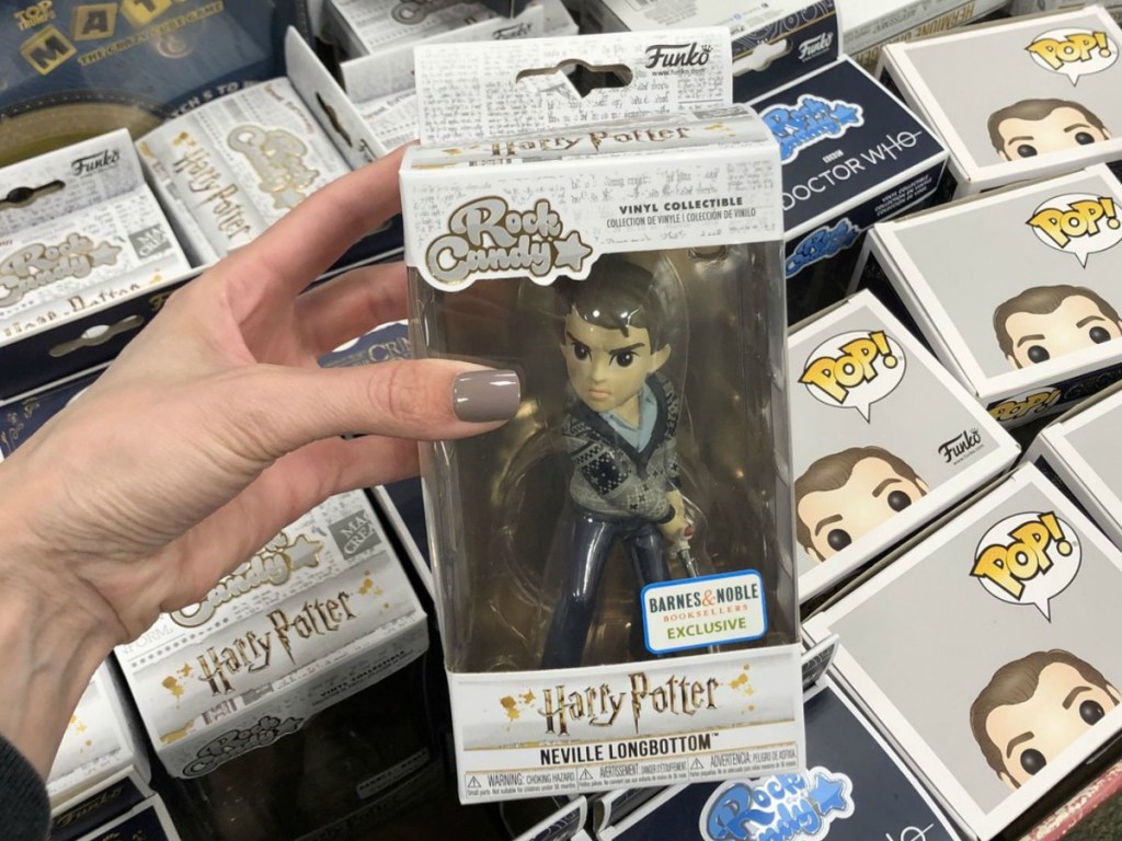 hand holding boxed toy by store display