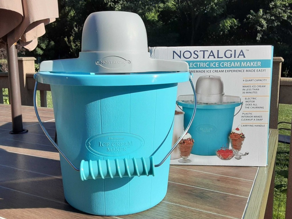 teal bucket-style ice cream maker next to box