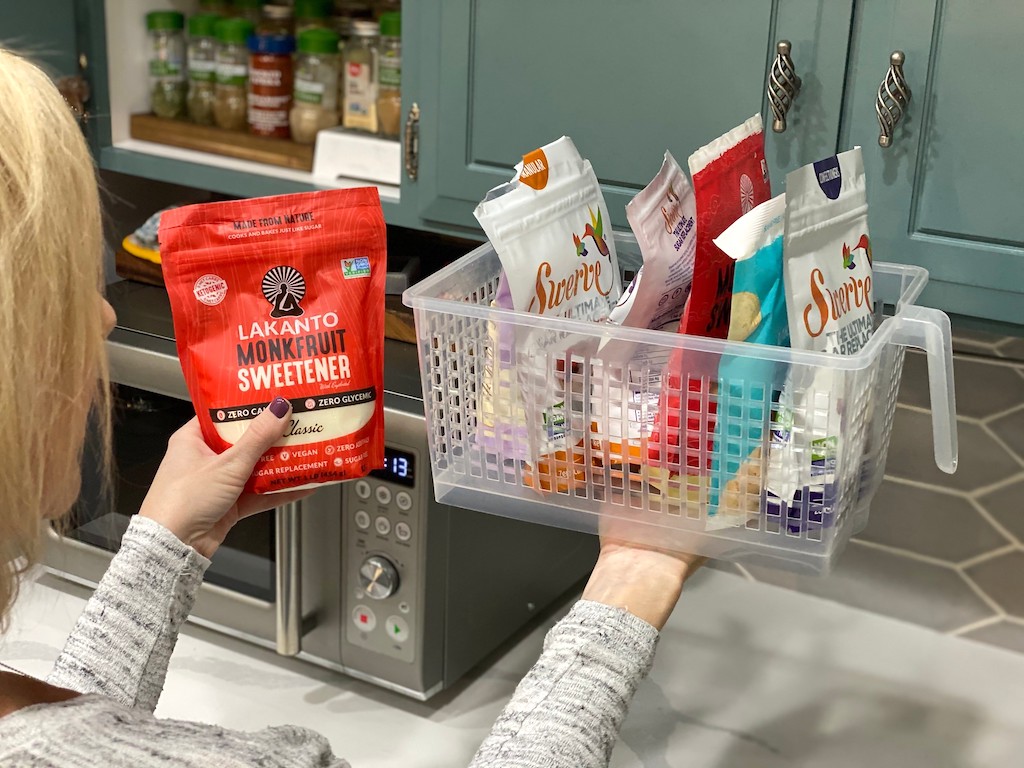 woman organizing pantry basket with sugar alternatives 