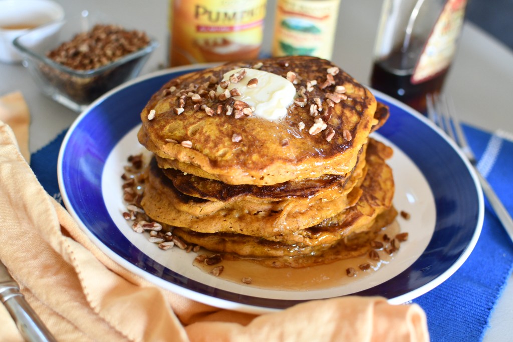 plate of pumpkin pancakes with pecans
