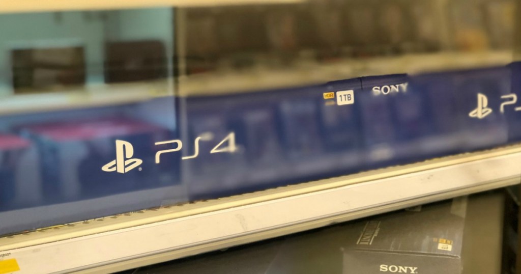 playstation gaming system behind glass on store shelf
