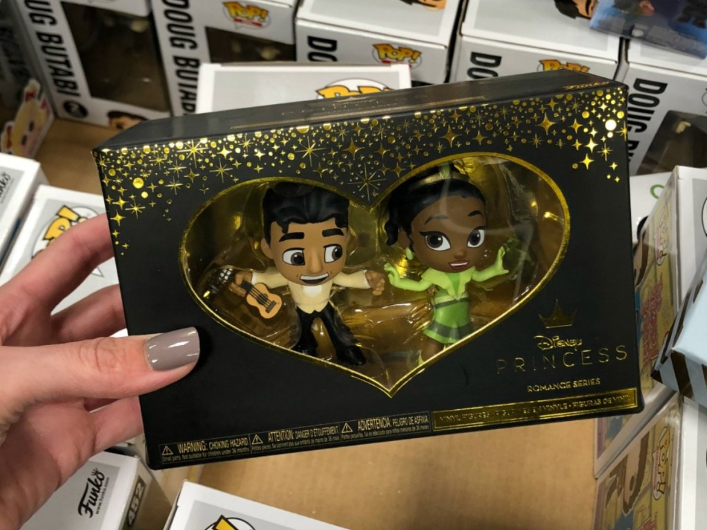 hand holding box of 2 figurines in store