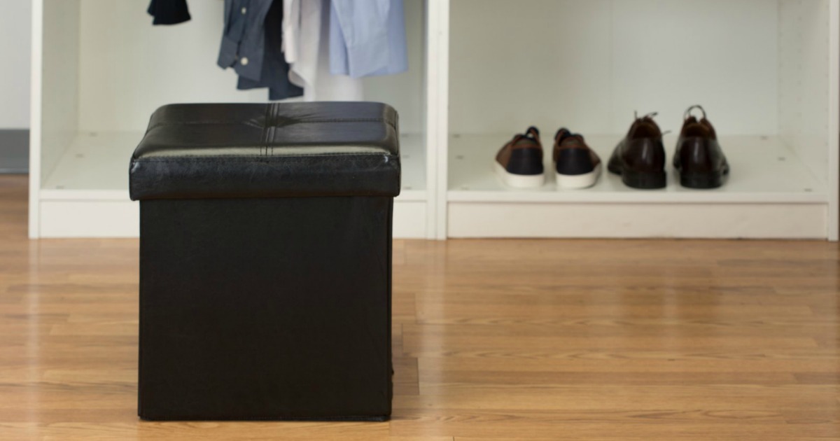 black storage ottoman in closet