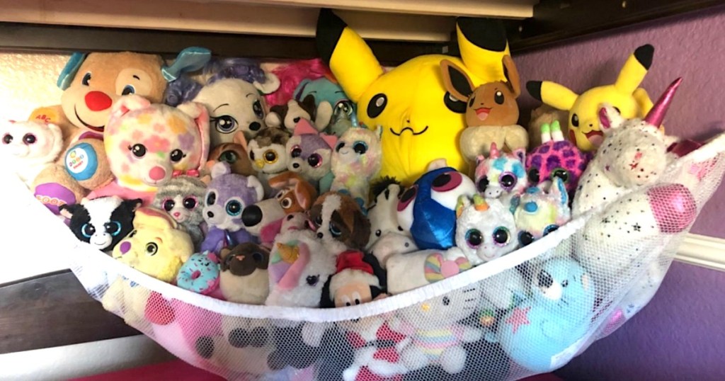 toy hammock filled with stuffed animals hanging on wall 