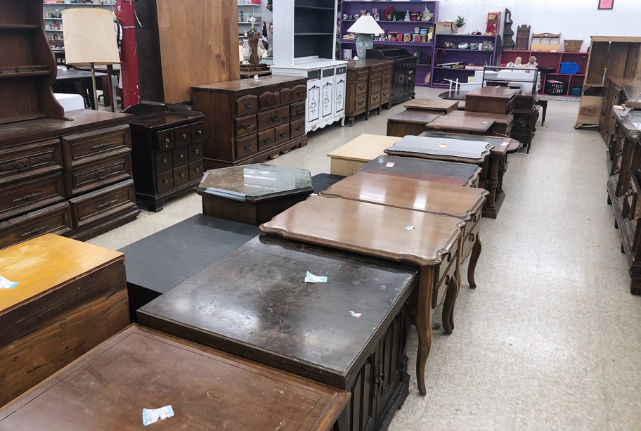 end tables, coffee tables, and dressers at thrift store