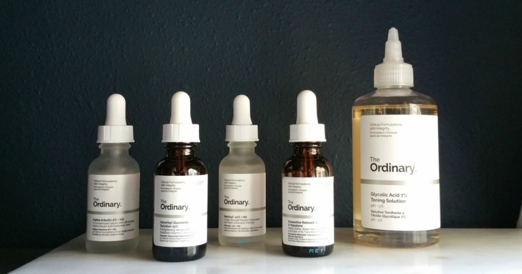 row of clear and brown amber dropper bottle beauty products with the ordinary labels on front