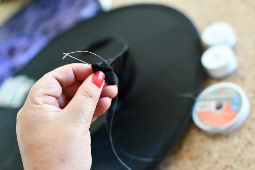 using a sewing needle to hang witch hats