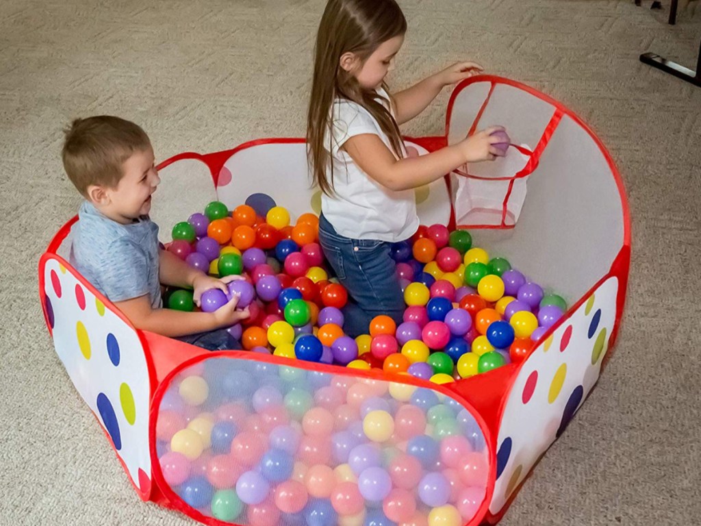 kids playing basketball in a ball pit