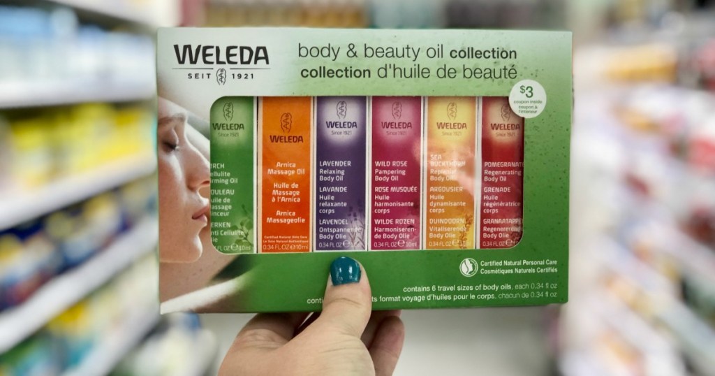 hand holding weleda collection with blurred background