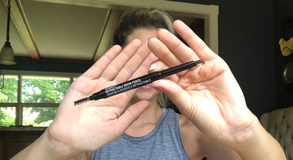 emily holding up wet n wild brow pencil