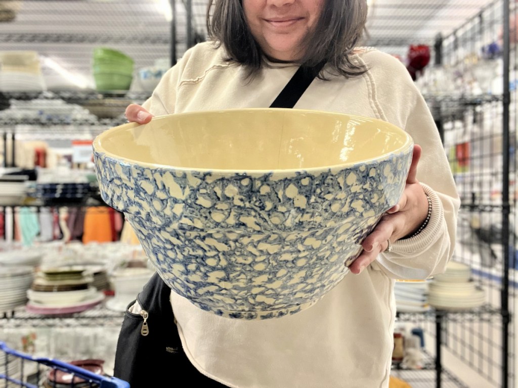 woman in goodwill holding a bowl