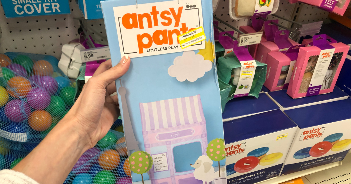 hand holding up antsy pants play cover box