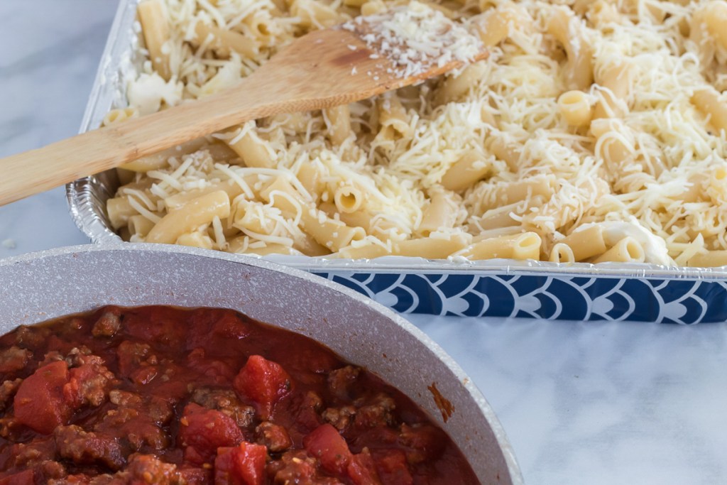 tomato sauce and pasta with shredded cheese