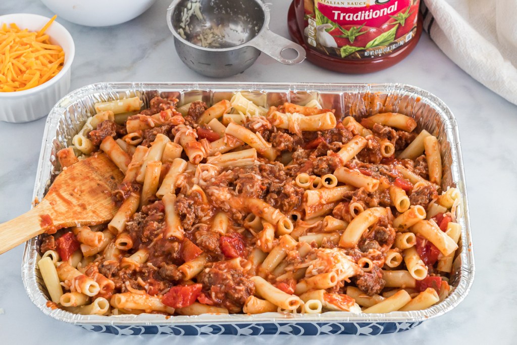 ziti mixed with sauce, meat and cheese
