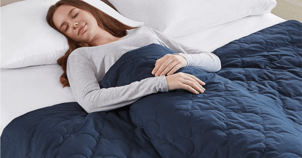 woman sleeping with blue weighted blanket