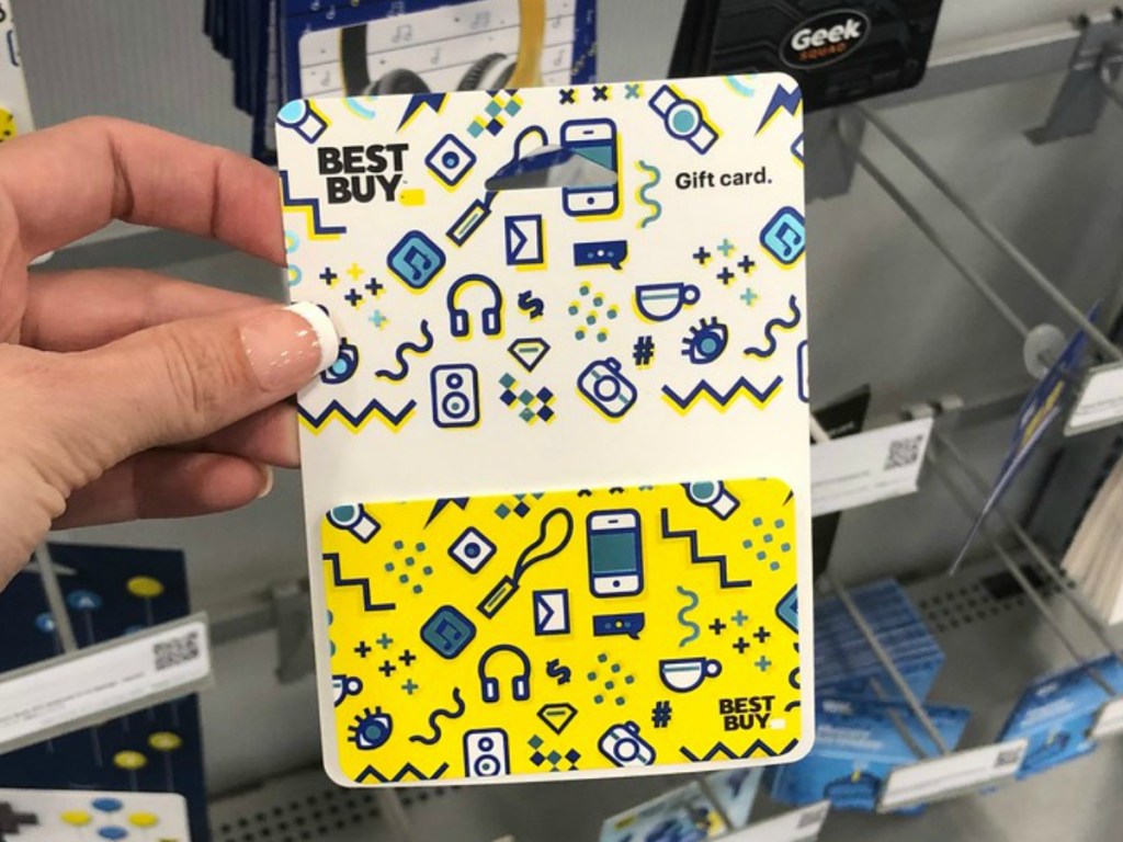 hand holding gift card by store display
