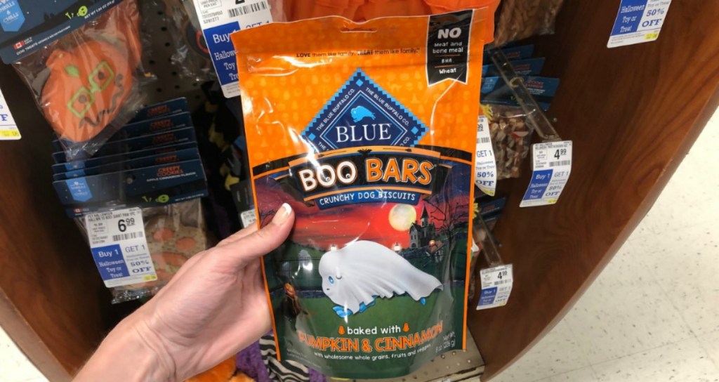 woman holding Blue Buffalo Boo Bars dog treats