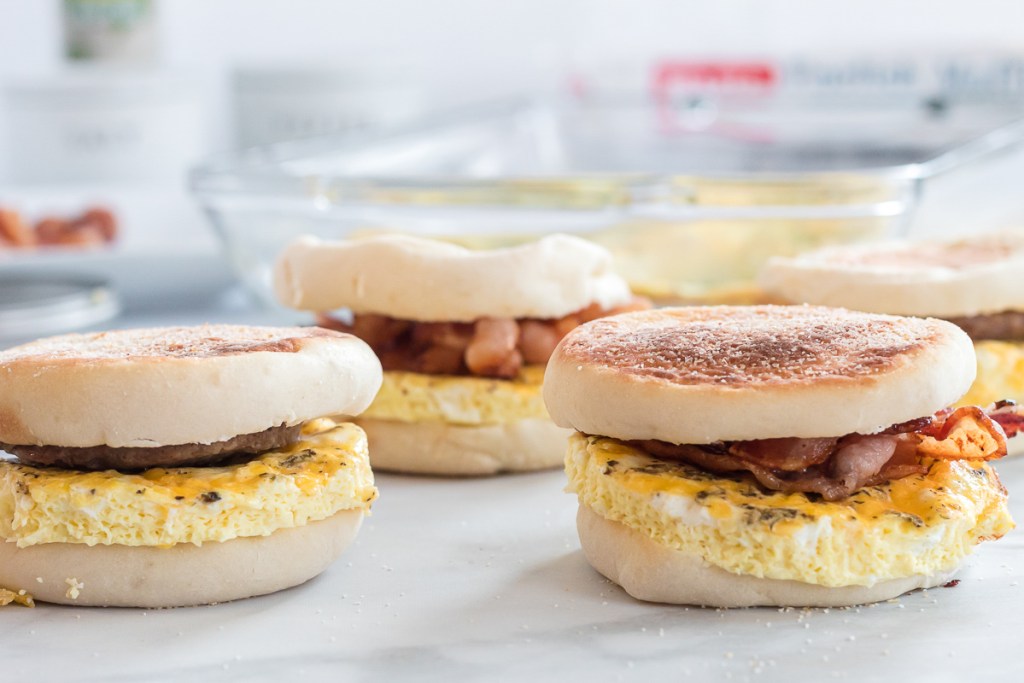 Breakfast sandwiches with bacon on counter