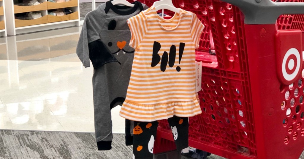 Cat & Jack Halloween Baby Clothing hanging on a Target cart