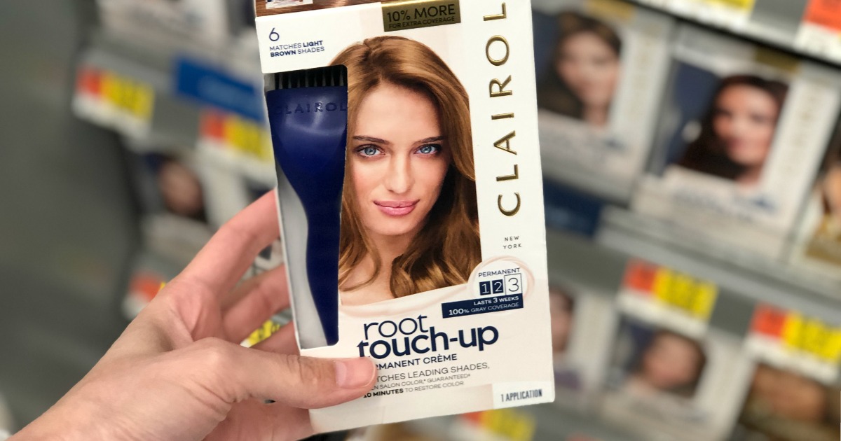 Clairol Root Touch-Up being held by a woman's hand