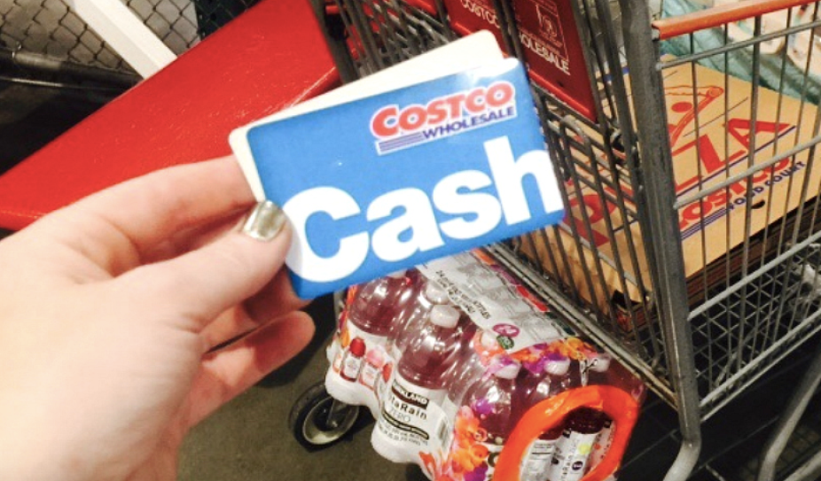 Woman holding Costco Cash Card
