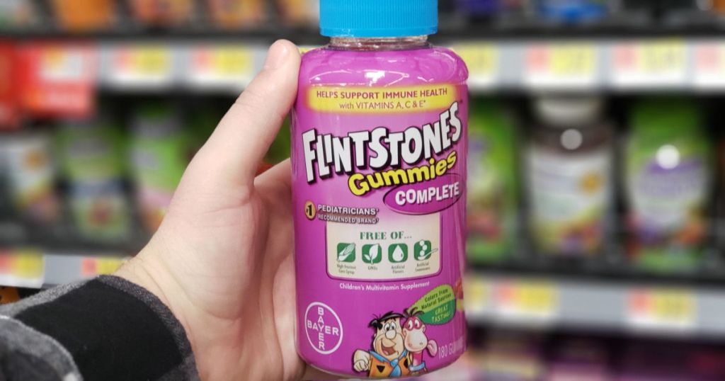 hand holding up bottle of flinstones vitamins