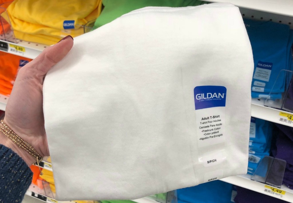 Gildan adult tee in white in hand in-store