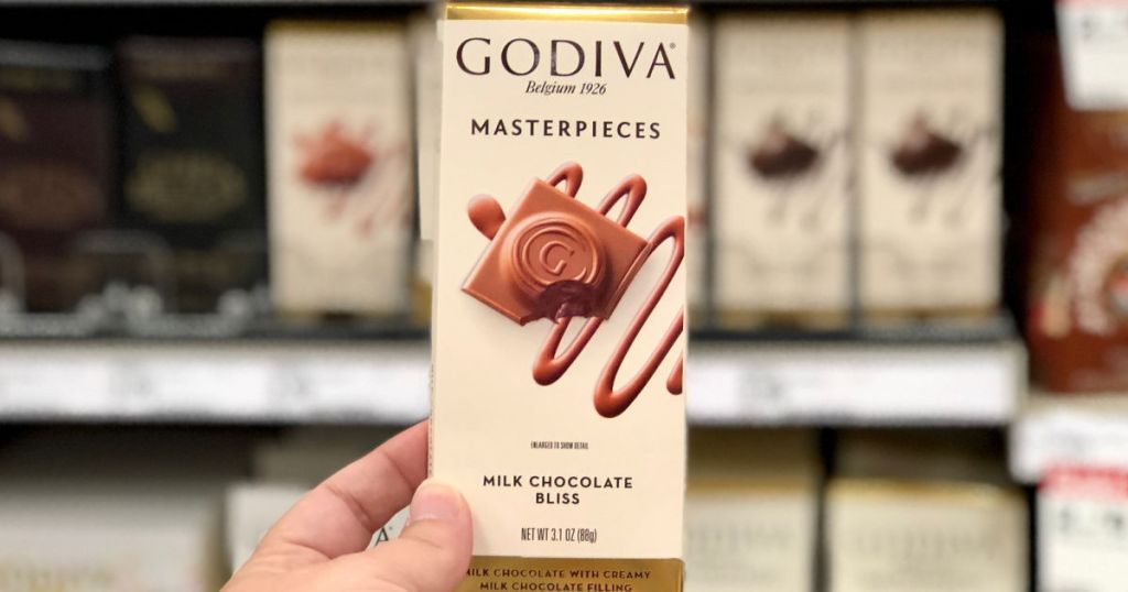 hand holding up godiva chocolate bar